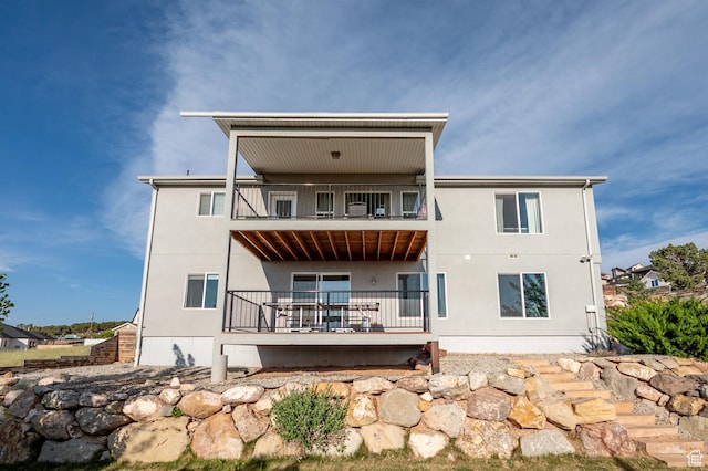 48 S Cimarron Cir, Cedar City, UT 84720 - rear view of house with a balcony and stucco siding