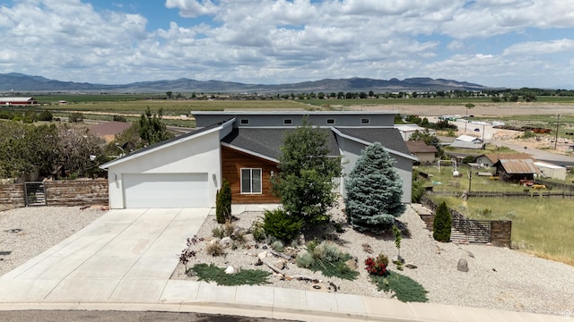 48 S Cimarron Cir, Cedar City, UT 84720 - contemporary home featuring a garage, driveway, and a mountain view