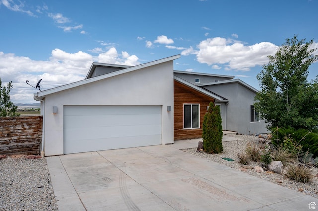48 S Cimarron Cir, Cedar City, UT 84720 - view of front facade with a garage, driveway, and stucco siding