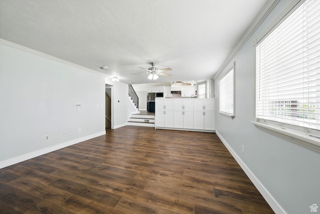 1826 N 2600 W, Lehi, UT 84043 - unfurnished living room with stairway, baseboards, a ceiling fan, dark wood finished floors, and ornamental molding