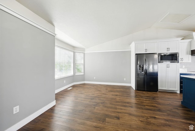 1826 N 2600 W, Lehi, UT 84043 - kitchen with refrigerator with ice dispenser, stainless steel microwave, vaulted ceiling, white cabinets, and dark wood finished floors