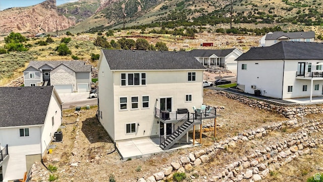228 E 600 S, Willard, UT 84340 - back of property with cooling unit, a patio area, a residential view, and stairway