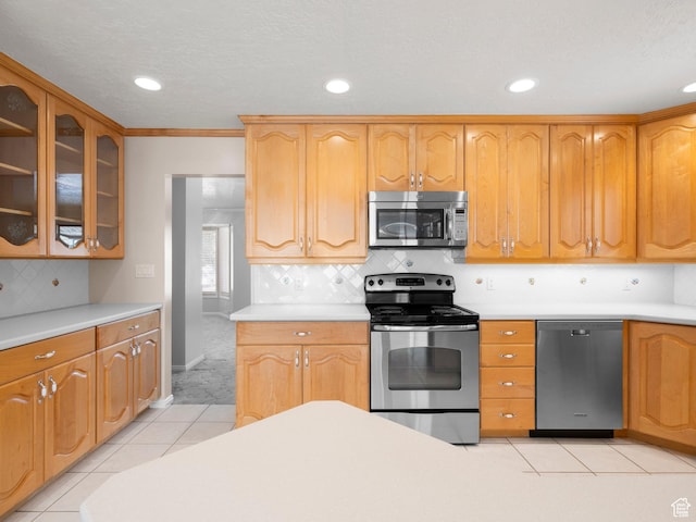 9751 S Garnet Dr, Sandy, UT 84094 - kitchen with appliances with stainless steel finishes, light countertops, glass insert cabinets, and recessed lighting