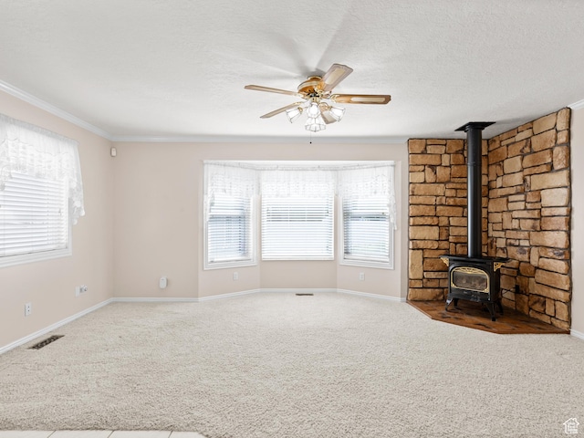 9751 S Garnet Dr, Sandy, UT 84094 - unfurnished living room with a wood stove, ceiling fan, crown molding, carpet floors, and baseboards