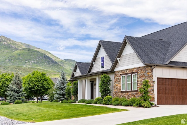 1123 Dutch Fields Pkwy, Midway, UT 84049 - view of front of property with a mountain view, a front lawn, a garage, stone siding, and concrete driveway