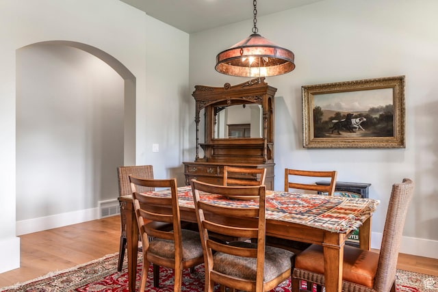 1123 Dutch Fields Pkwy, Midway, UT 84049 - dining room with arched walkways, wood finished floors, and baseboards