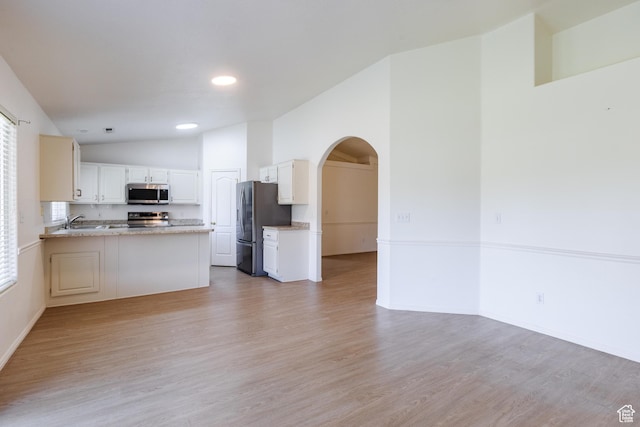 710 S Indian Hills Dr # 64, St George, UT 84770 - kitchen featuring appliances with stainless steel finishes, arched walkways, open floor plan, light wood-style floors, and recessed lighting