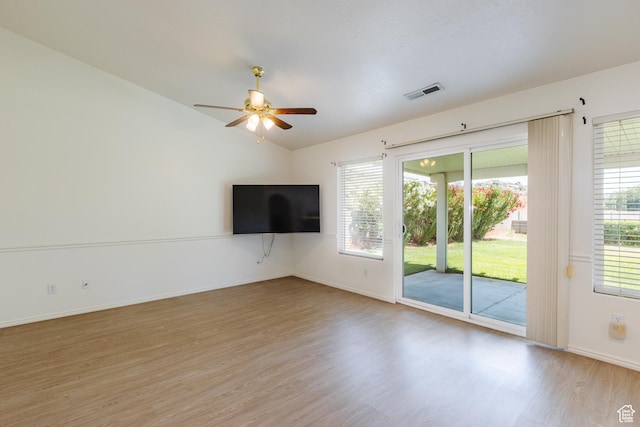 710 S Indian Hills Dr # 64, St George, UT 84770 - unfurnished living room featuring light wood-type flooring, a ceiling fan, lofted ceiling, baseboards, and plenty of natural light