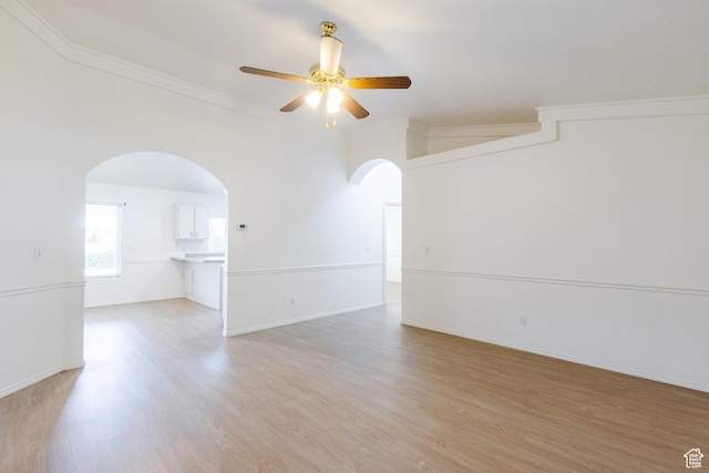 710 S Indian Hills Dr # 64, St George, UT 84770 - empty room with arched walkways, ceiling fan, light wood-type flooring, crown molding, and baseboards