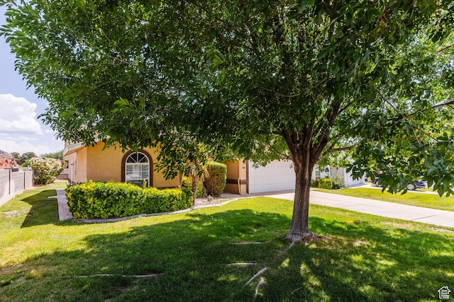 710 S Indian Hills Dr # 64, St George, UT 84770 - obstructed view of property featuring stucco siding, concrete driveway, and an attached garage
