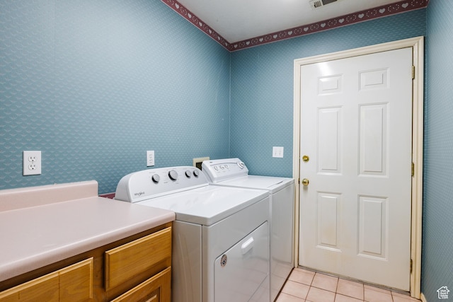 710 S Indian Hills Dr # 64, St George, UT 84770 - laundry area featuring washing machine and dryer, light tile patterned flooring, wallpapered walls, and cabinet space