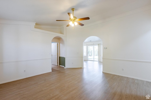 710 S Indian Hills Dr # 64, St George, UT 84770 - unfurnished room with arched walkways, a ceiling fan, light wood finished floors, ornamental molding, and baseboards