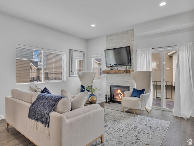 3877 S 1655 W, West Valley City, UT 84119 - living room featuring healthy amount of natural light, wood finished floors, a fireplace, and recessed lighting
