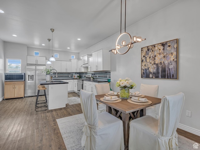 3877 S 1655 W, West Valley City, UT 84119 - dining area with wood finished floors, recessed lighting, a chandelier, and baseboards