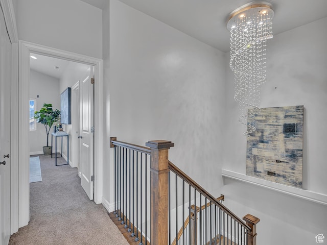 3877 S 1655 W, West Valley City, UT 84119 - hall featuring an upstairs landing, a chandelier, carpet, and baseboards