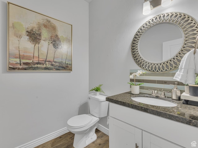 3877 S 1655 W, West Valley City, UT 84119 - half bath with wood finished floors, vanity, toilet, and baseboards