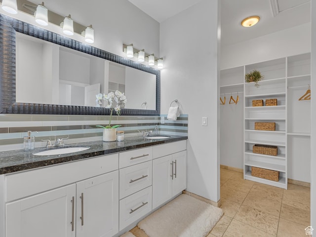 3877 S 1655 W, West Valley City, UT 84119 - bathroom with double vanity, baseboards, tile patterned floors, and a walk in closet