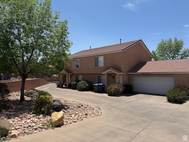 1087 N 1800th Cir W, St George, UT 84770 - view of front facade with concrete driveway, an attached garage, and stucco siding