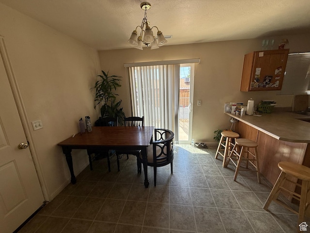 1087 N 1800th Cir W, St George, UT 84770 - dining space with a chandelier, baseboards, and dark tile patterned floors