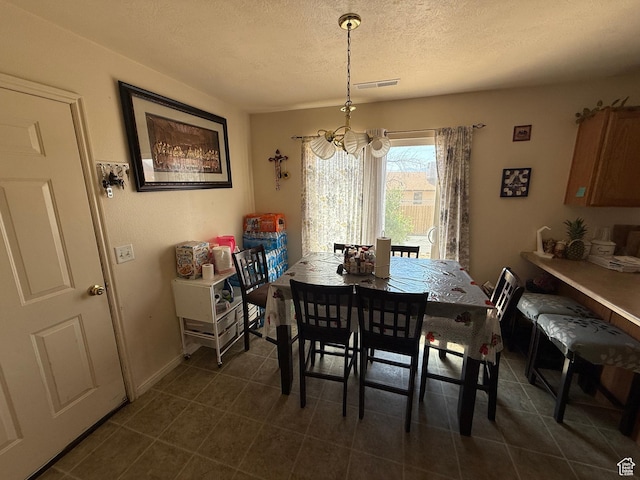 1087 N 1800th Cir W, St George, UT 84770 - dining area with a textured ceiling, a chandelier, and dark tile patterned floors