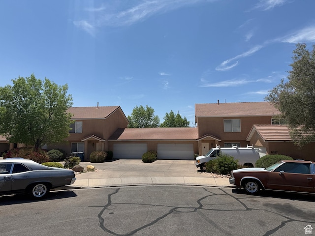 1087 N 1800th Cir W, St George, UT 84770 - view of front of property with an attached garage, stucco siding, concrete driveway, and a tiled roof