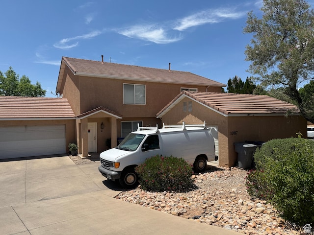 1087 N 1800th Cir W, St George, UT 84770 - view of front of house featuring a garage, concrete driveway, stucco siding, and a tiled roof