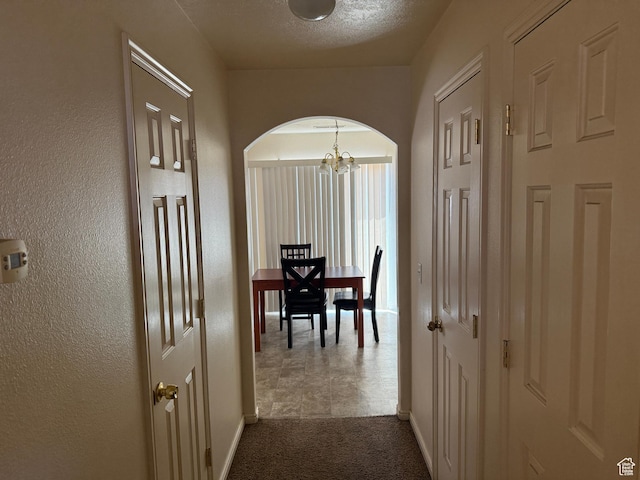 1087 N 1800th Cir W, St George, UT 84770 - hall with a chandelier, arched walkways, baseboards, and dark carpet