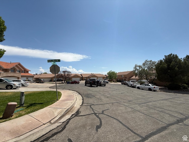 1087 N 1800th Cir W, St George, UT 84770 - view of asphalt street with a residential view, sidewalks, traffic signs, and curbs