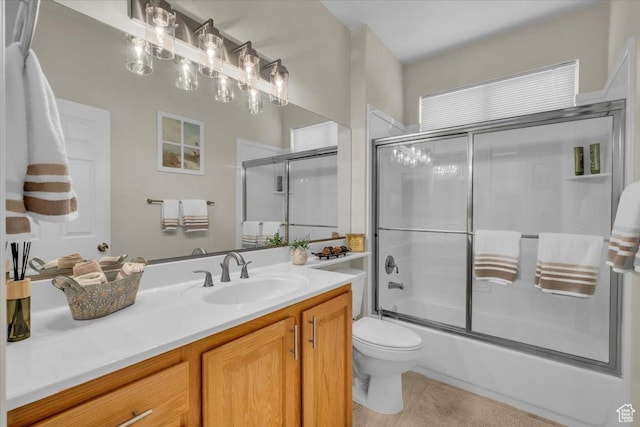1646 W Sunkissed Dr, St George, UT 84790 - bathroom featuring toilet, vanity, combined bath / shower with glass door, and tile patterned floors