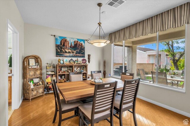 1646 W Sunkissed Dr, St George, UT 84790 - dining room featuring baseboards, light wood-type flooring, and healthy amount of natural light