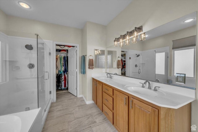 1646 W Sunkissed Dr, St George, UT 84790 - full bath featuring a spacious closet, a shower stall, double vanity, baseboards, and a bath