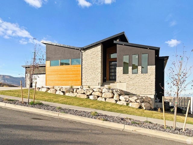 7272 W Summit Crest Cir, Herriman, UT 84096 - view of home's exterior featuring stone siding, a lawn, a mountain view, and stucco siding