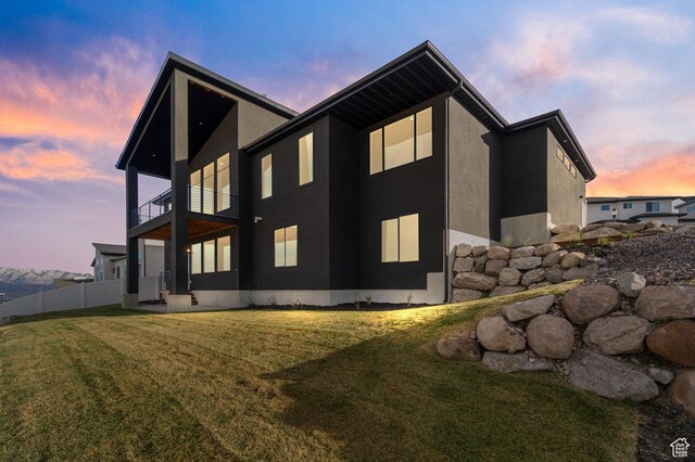 7272 W Summit Crest Cir, Herriman, UT 84096 - property exterior at dusk with a balcony and stucco siding