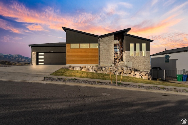7272 W Summit Crest Cir, Herriman, UT 84096 - contemporary home featuring stone siding, concrete driveway, and a garage