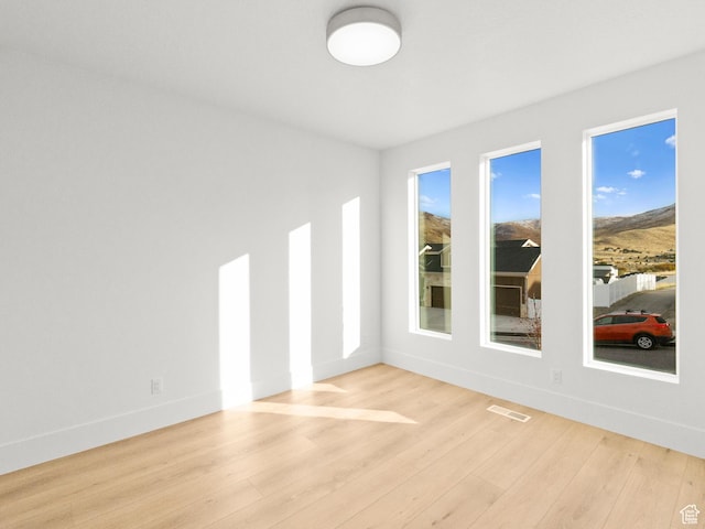 7272 W Summit Crest Cir, Herriman, UT 84096 - empty room with wood finished floors and a mountain view