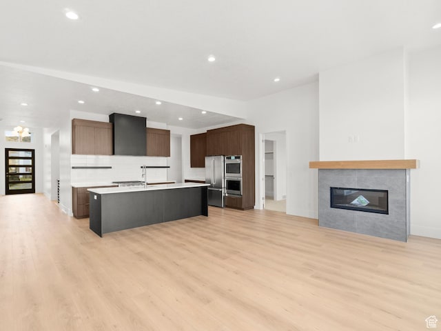 7272 W Summit Crest Cir, Herriman, UT 84096 - kitchen featuring a center island with sink, light wood-style flooring, high quality fridge, light countertops, and recessed lighting