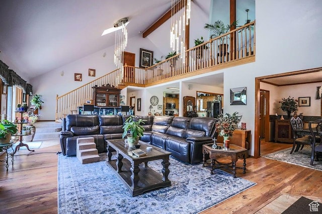 580 S Stagecoach Dr, Brookside, UT 84782 - living room featuring high vaulted ceiling, stairs, wood finished floors, and beam ceiling
