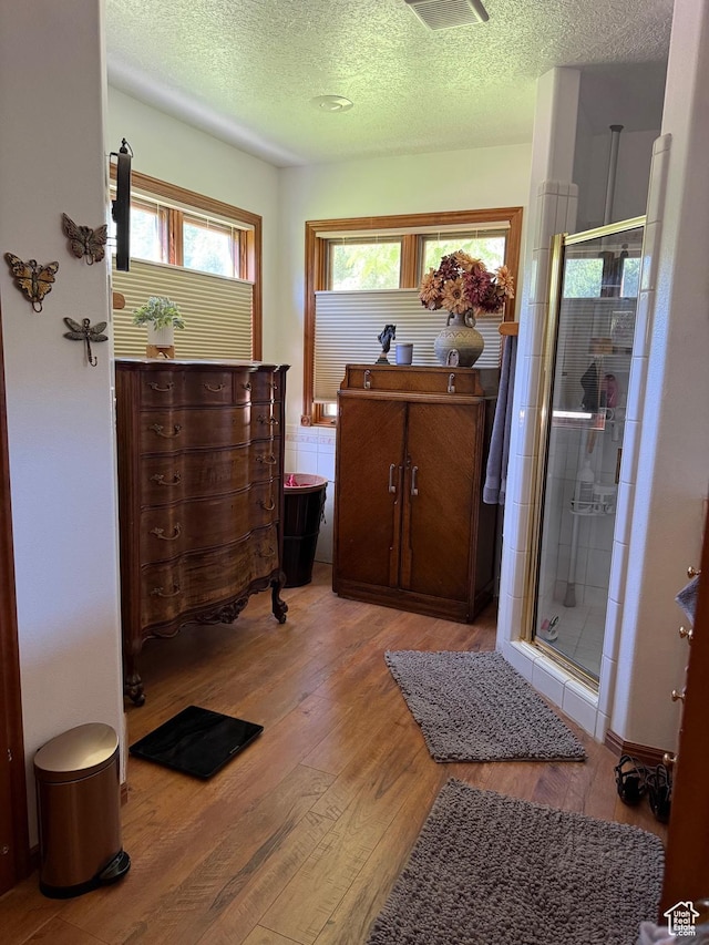 580 S Stagecoach Dr, Brookside, UT 84782 - bathroom with wood finished floors, a stall shower, a textured ceiling, and vanity
