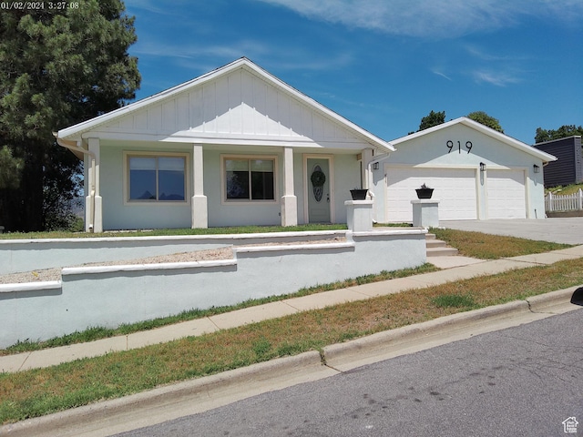 919 E Millbrook Way, Bountiful, UT 84010 - view of front facade with board and batten siding, covered porch, and driveway