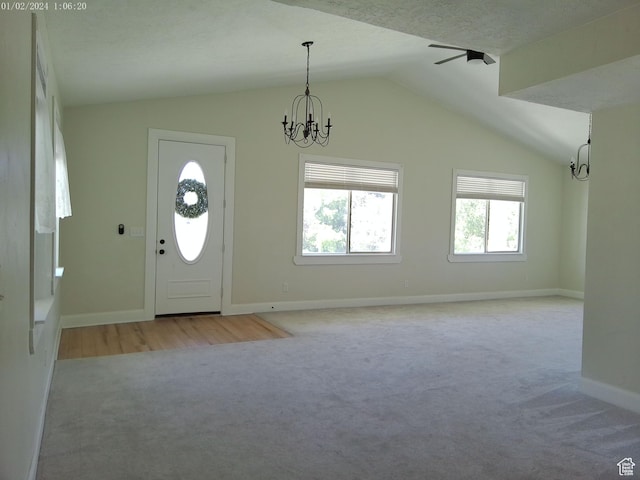 919 E Millbrook Way, Bountiful, UT 84010 - entrance foyer featuring light colored carpet, lofted ceiling, a chandelier, healthy amount of natural light, and baseboards