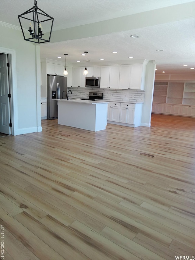 919 E Millbrook Way, Bountiful, UT 84010 - kitchen featuring stainless steel appliances, open floor plan, recessed lighting, decorative backsplash, and white cabinets