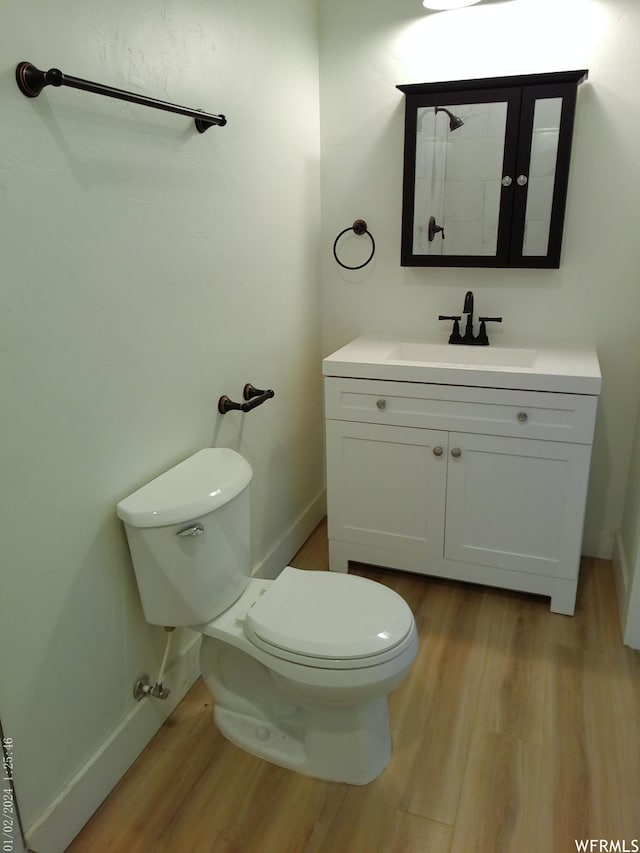 919 E Millbrook Way, Bountiful, UT 84010 - bathroom featuring wood finished floors, toilet, vanity, and baseboards