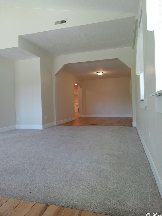 919 E Millbrook Way, Bountiful, UT 84010 - empty room with arched walkways, carpet floors, and baseboards