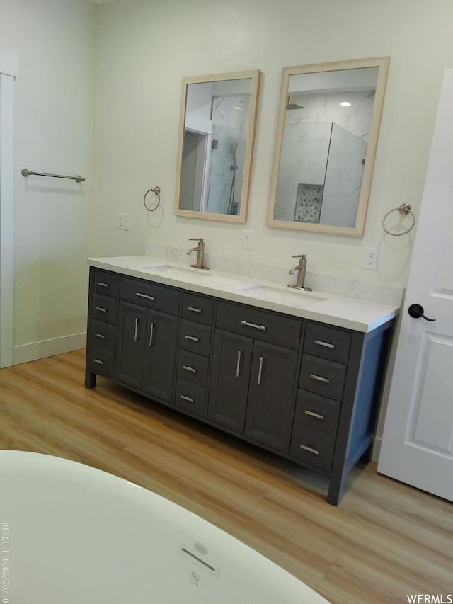 919 E Millbrook Way, Bountiful, UT 84010 - bathroom featuring double vanity, wood finished floors, baseboards, and a shower