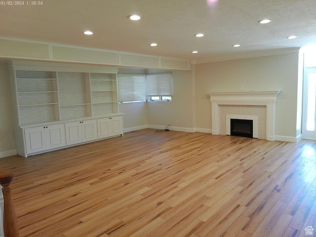 919 E Millbrook Way, Bountiful, UT 84010 - unfurnished living room with recessed lighting, light wood finished floors, a tile fireplace, baseboards, and ornamental molding
