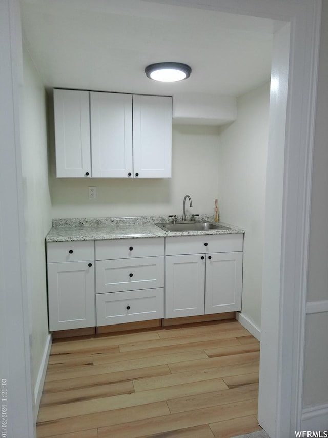 919 E Millbrook Way, Bountiful, UT 84010 - kitchen featuring a sink, light wood-style floors, white cabinetry, and light stone countertops