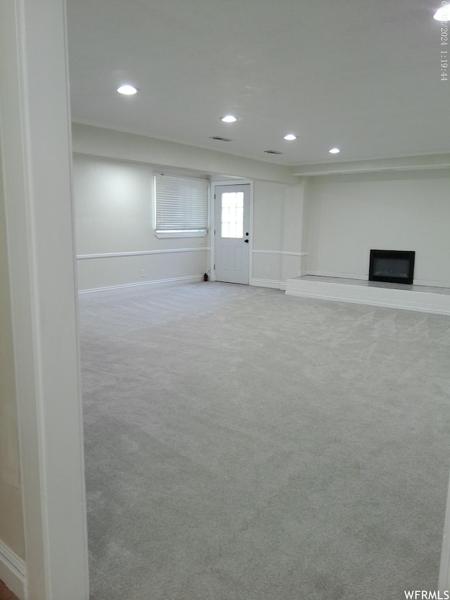 919 E Millbrook Way, Bountiful, UT 84010 - basement featuring baseboards, a glass covered fireplace, carpet flooring, and recessed lighting