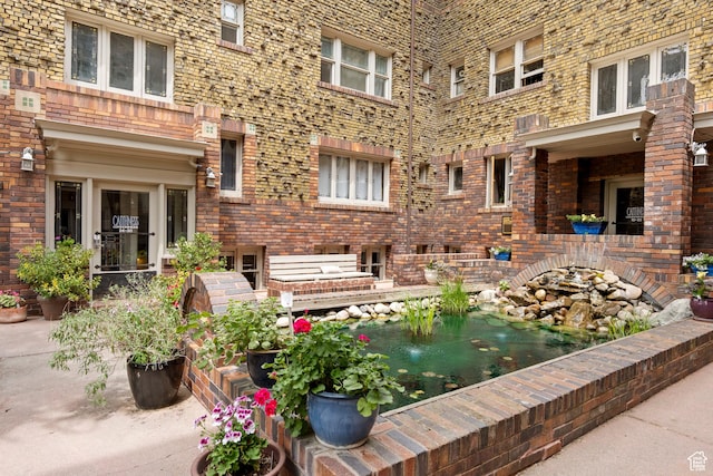 86 B St E Unit 24, Salt Lake City, UT 84150 - view of patio featuring a small pond