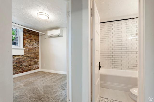 86 B St E Unit 24, Salt Lake City, UT 84150 - bathroom with a wall mounted AC, a textured ceiling, toilet, baseboards, and bathing tub / shower combination