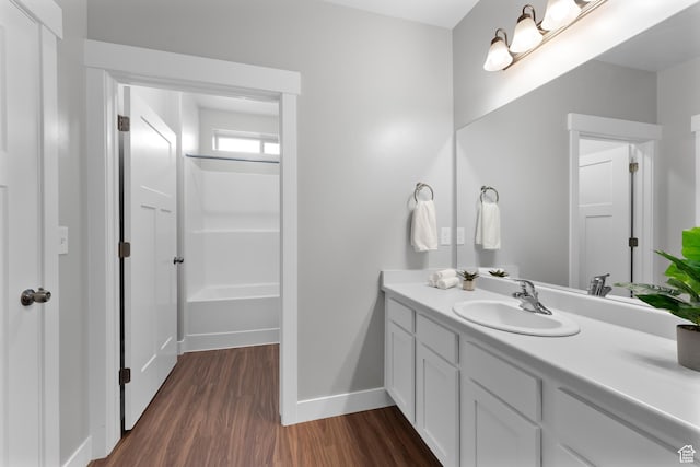 1809 W Terra Vista Ln N Unit B1, Saratoga Springs, UT 84045 - bathroom featuring vanity, wood finished floors, baseboards, and bathtub / shower combination